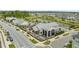 Aerial view of a market, surrounded by neighborhood housing and a pond with landscaping at 6618 Perry Creek Rd, Raleigh, NC 27616