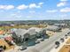 Aerial view of the community features a central pond and nearby restaurants at 6618 Perry Creek Rd, Raleigh, NC 27616