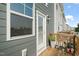 Back porch of townhome features a wooden deck and exterior door with glass window at 6618 Perry Creek Rd, Raleigh, NC 27616