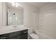 Bathroom features a vanity with dark cabinets, tub-shower combo, and neutral color scheme at 6618 Perry Creek Rd, Raleigh, NC 27616