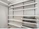 Walk-in closet with multiple shelves and wire storage baskets providing ample storage at 6618 Perry Creek Rd, Raleigh, NC 27616
