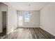 A bright dining room featuring a window, modern lighting, and a door with access to the backyard at 6618 Perry Creek Rd, Raleigh, NC 27616