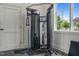 The fitness center features a cable machine, neutral tones, and a window for natural light at 6618 Perry Creek Rd, Raleigh, NC 27616