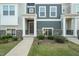Inviting front entrance with stone accents, a covered porch, and well-maintained landscaping at 6618 Perry Creek Rd, Raleigh, NC 27616