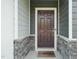 Charming front door with stone accents and covered porch at 6618 Perry Creek Rd, Raleigh, NC 27616
