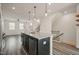 View of kitchen island featuring a sink, granite countertop, black cabinets, and stainless steel dishwasher at 6618 Perry Creek Rd, Raleigh, NC 27616