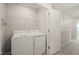 Laundry room features a white washer and dryer, wire rack shelf and white walls at 6618 Perry Creek Rd, Raleigh, NC 27616