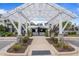 Pool entrance with arbor, black fence, and lush landscaping with clear signage for community members at 6618 Perry Creek Rd, Raleigh, NC 27616
