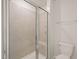 Bathroom featuring a glass enclosed shower with tiled walls and a built-in seat at 6618 Perry Creek Rd, Raleigh, NC 27616