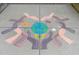 Sidewalk chalk art depicts hands embracing a globe, symbolizing community and environmental awareness at 6618 Perry Creek Rd, Raleigh, NC 27616