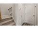 Carpeted staircase leading to the upper level of the home with natural wood railing at 6618 Perry Creek Rd, Raleigh, NC 27616