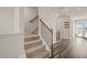 Carpeted staircase leading to the upper level with hardwood floors in the background at 6618 Perry Creek Rd, Raleigh, NC 27616