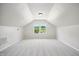 Finished attic space with carpet and a window showing the exterior at 8509 Ashwood Dr, Raleigh, NC 27603