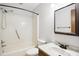Bathroom features a vanity, mirror, toilet, and shower tub combo with a handheld shower head at 8509 Ashwood Dr, Raleigh, NC 27603
