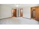 Spacious bedroom with neutral carpet, ceiling fan, two closets, and doors to access to other rooms at 8509 Ashwood Dr, Raleigh, NC 27603