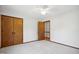 Bright bedroom with carpet flooring features a ceiling fan and double door closet at 8509 Ashwood Dr, Raleigh, NC 27603