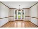 Bright dining area with elegant chandelier and sun-filled windows at 8509 Ashwood Dr, Raleigh, NC 27603