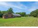 Single-story brick home boasting a lush green lawn and mature trees at 8509 Ashwood Dr, Raleigh, NC 27603