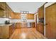 Cozy kitchen featuring granite countertops, wood cabinets, and stainless appliances at 8509 Ashwood Dr, Raleigh, NC 27603