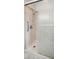 Walk-in shower featuring a glass door, shower head, and grab bar at 8509 Ashwood Dr, Raleigh, NC 27603