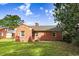 Brick home featuring a backyard with grass and landscaping at 905 S 1St St, Smithfield, NC 27577