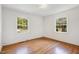 Bright bedroom with hardwood floors and two windows at 905 S 1St St, Smithfield, NC 27577