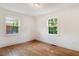Bright bedroom with hardwood floors and two windows offering natural light at 905 S 1St St, Smithfield, NC 27577