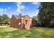 Charming brick home featuring a well-maintained lawn, mature trees, and an architectural roof at 905 S 1St St, Smithfield, NC 27577
