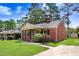 A quaint brick home with mature trees, offering a serene and inviting curb appeal at 905 S 1St St, Smithfield, NC 27577