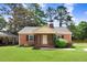 Charming brick home featuring a well-maintained front yard and traditional architectural details at 905 S 1St St, Smithfield, NC 27577