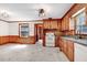 Traditional kitchen featuring wooden cabinetry, white appliances, and a functional layout at 905 S 1St St, Smithfield, NC 27577