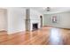 Spacious living room with a classic brick fireplace and gleaming hardwood floors at 905 S 1St St, Smithfield, NC 27577