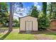 Exterior view of a backyard storage shed with double doors and ramp access at 905 S 1St St, Smithfield, NC 27577