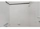 All-white tiled shower with black trim, and silver fixtures at 905 S 1St St, Smithfield, NC 27577