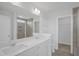 Modern bathroom featuring double sinks, a large mirror, and a glass-enclosed shower with tile surround at 91 Merle Way Way, Wendell, NC 27591