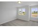 Neutral bedroom featuring plush carpeting and ample natural light from two large windows overlooking the yard at 91 Merle Way Way, Wendell, NC 27591