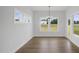 Bright dining room with hardwood floors, a chandelier, and plenty of natural light from the surrounding windows at 91 Merle Way Way, Wendell, NC 27591