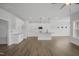 Bright open kitchen featuring white cabinetry, an island with pendant lighting, stainless steel appliances, and hardwood flooring at 91 Merle Way Way, Wendell, NC 27591