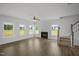 Spacious living room with hardwood floors, a fireplace, and plenty of natural light from the large windows at 91 Merle Way Way, Wendell, NC 27591