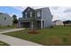Two-story home features attached two-car garage, green lawn, and fresh landscaping at 970 Bombardier Aly, Spring Hope, NC 27882