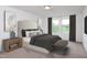 Bright bedroom featuring a large bed, soft carpet, and natural light from two large windows at 970 Bombardier Aly, Spring Hope, NC 27882