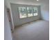 Bright bedroom with ample natural light from three windows and neutral carpet at 1002 Regalia Rd # 2, Durham, NC 27713
