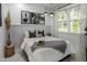 Comfortable bedroom with many decorations, framed artwork, natural light, and bright walls at 1002 Regalia Rd # 2, Durham, NC 27713
