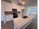 Bright, modern kitchen features an island, stainless appliances, and sleek countertops at 1004 Regalia Rd # 3, Durham, NC 27713