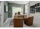 Stylish home office featuring paneled green walls, wood desk, and lots of natural light at 1004 Regalia Rd # 3, Durham, NC 27713