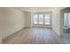 Spacious bedroom with wood-look floors, bright natural light, and an adjacent bathroom at 1006 Regalia Rd # 4, Durham, NC 27713