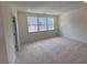 Bright bedroom with plush carpet, three windows, and neutral paint at 1006 Regalia Rd # 4, Durham, NC 27713