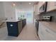 Modern kitchen with white cabinets, stainless steel appliances, and a center island with sink at 1006 Regalia Rd # 4, Durham, NC 27713