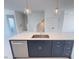 Kitchen island with stainless steel sink, dishwasher, navy cabinets and pendant lights at 1006 Regalia Rd # 4, Durham, NC 27713
