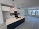 Bright, modern kitchen with stainless steel appliances, island, and white cabinets open to the dining area at 1006 Regalia Rd # 4, Durham, NC 27713